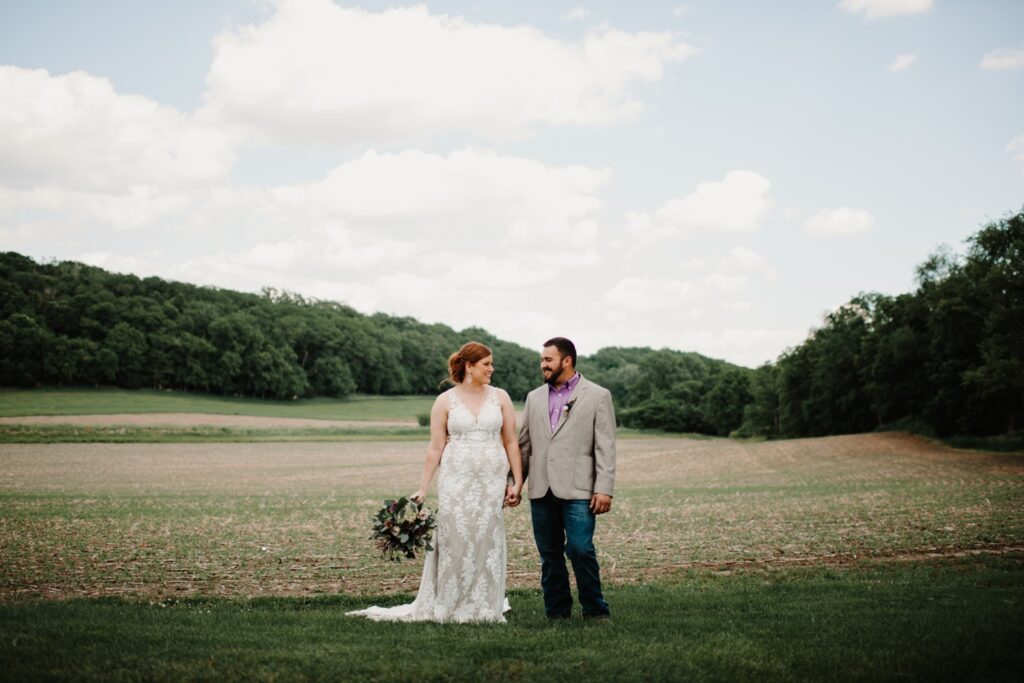 Bride and groom standing in fields at Reichert's Barn wedding