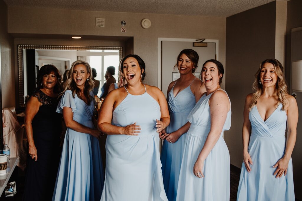 Bridesmaids seeing bride for first time before golf course wedding