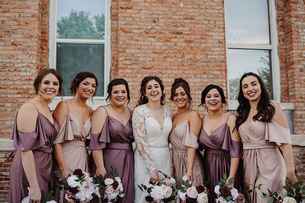 Bride and bridesmaids in front of the Legacy Building