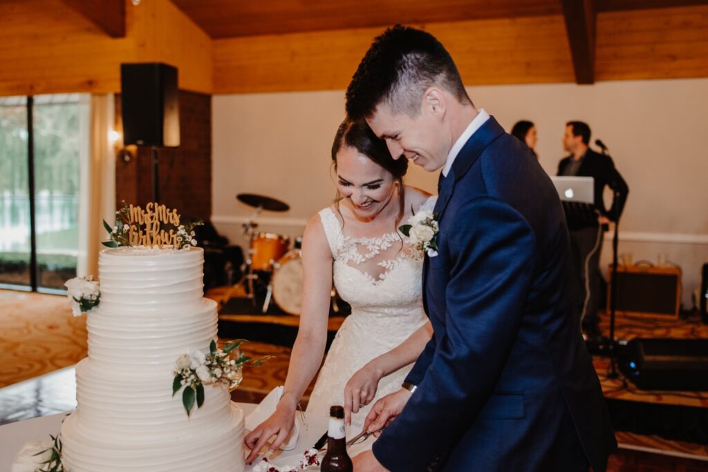 Bride and groom cut cake at golf course wedding