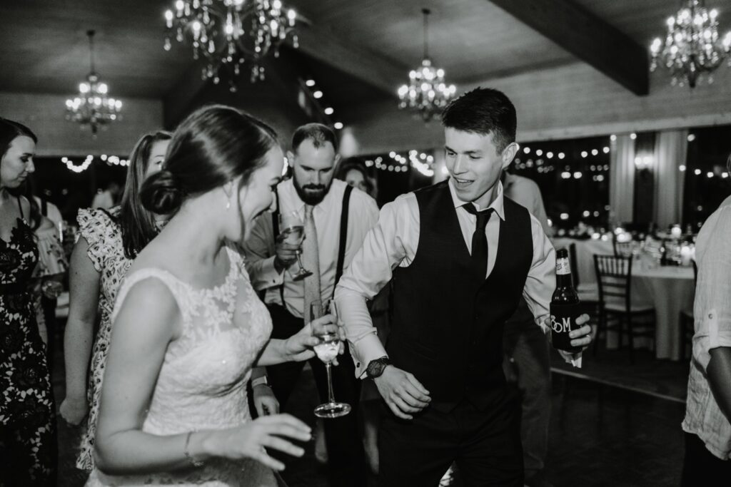 Bride and groom dance at golf course wedding reception
