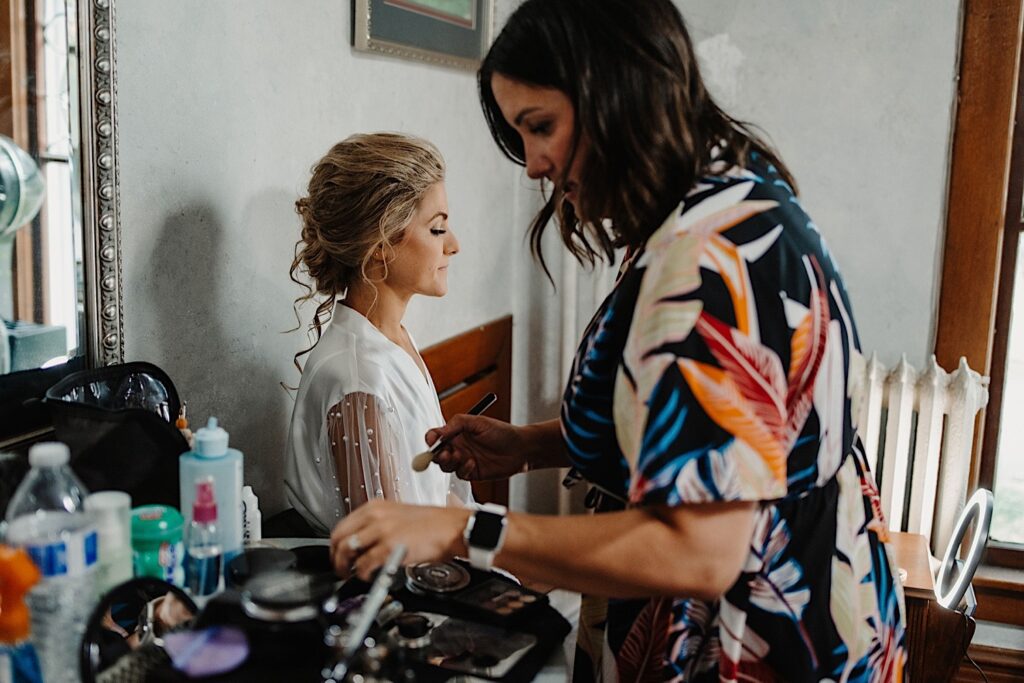 A bride getting makeup touch ups prior to her Chicago wedding day.