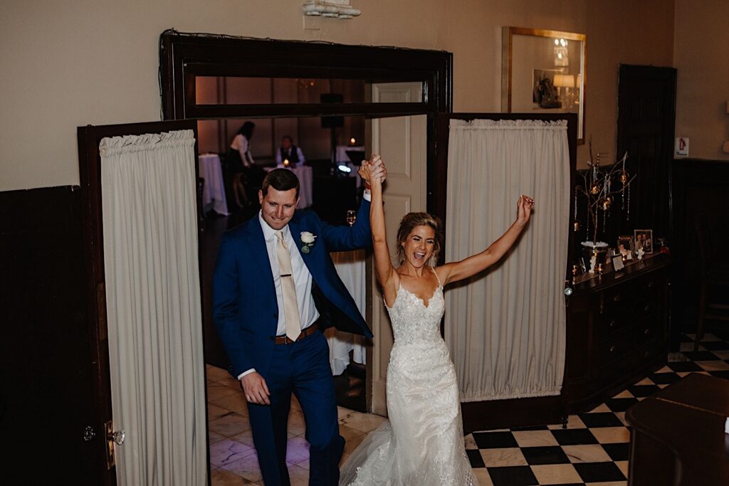 A bride and groom run into their wedding reception at Salvatores their Chicagoland wedding venue