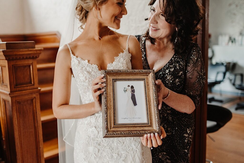 The bride gifts her mother with a drawing of the two of them on her wedding day.