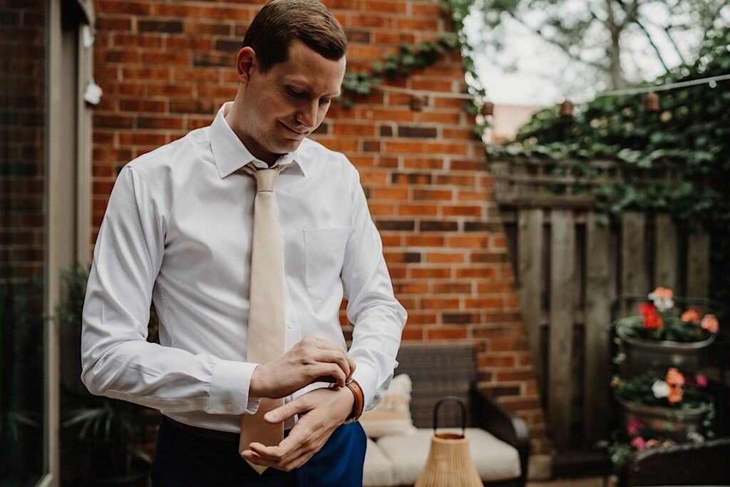A groom gets ready for his wedding day outside his Chicago apartment.