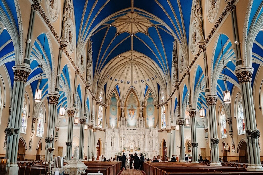 A wide photo of the inside of St. Alphonsus Church in Chicago the day of a wedding.