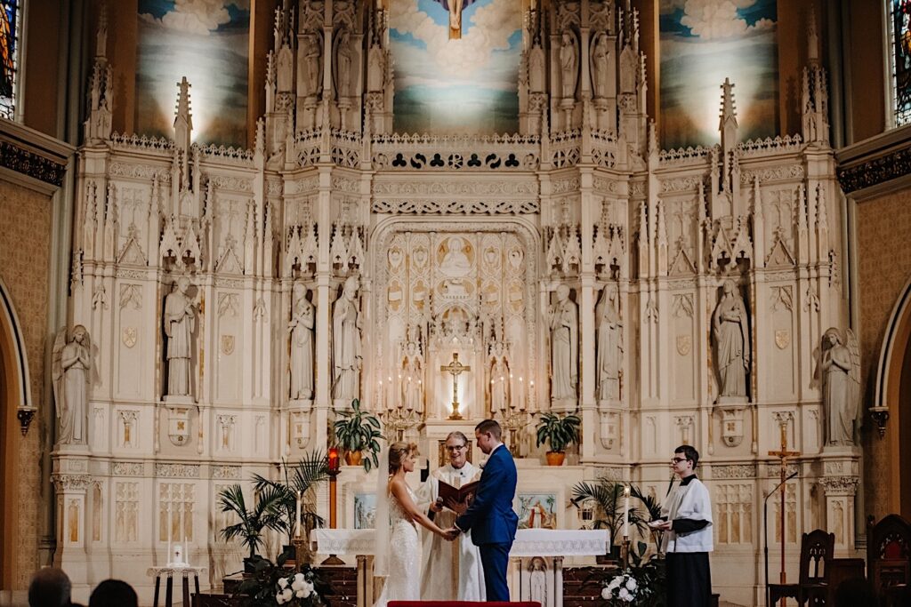 A couple shares their vows during their ceremony at St. Alphonsus church in Chicago