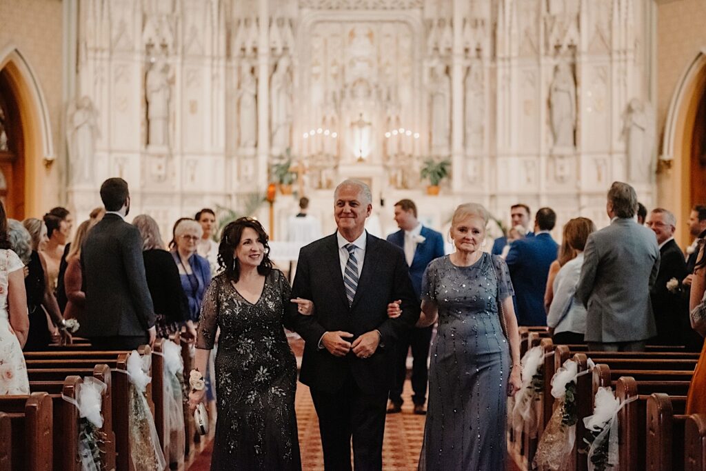 Guests walk out of the ceremony space following a wedding at St Alphonsus Chuch in Chicago