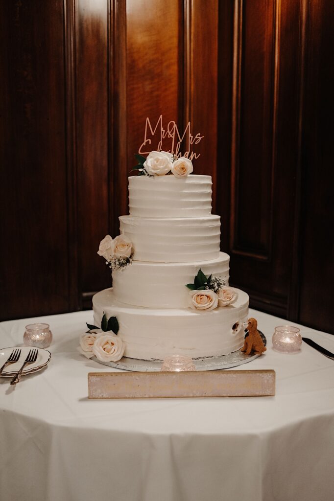 Photo of a wedding cake with flowers and candles around it