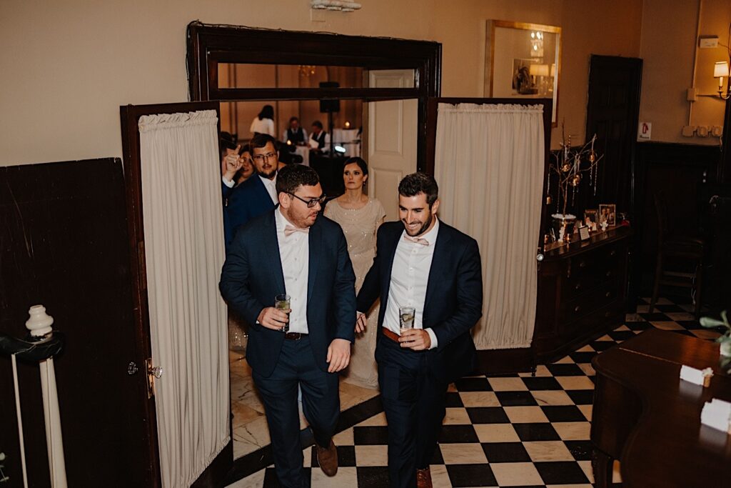 Wedding guests enter the reception space at Salvatore's in Chicago to celebrate a wedding