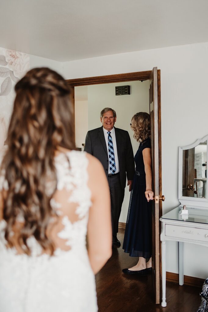The father of the bride sees his daughter for the first time on her wedding day.