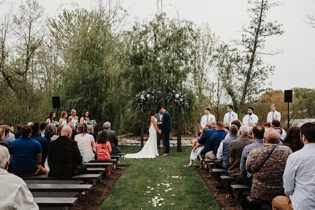 A wide photo of a couple getting married at 1841 Farms and Vineyard.