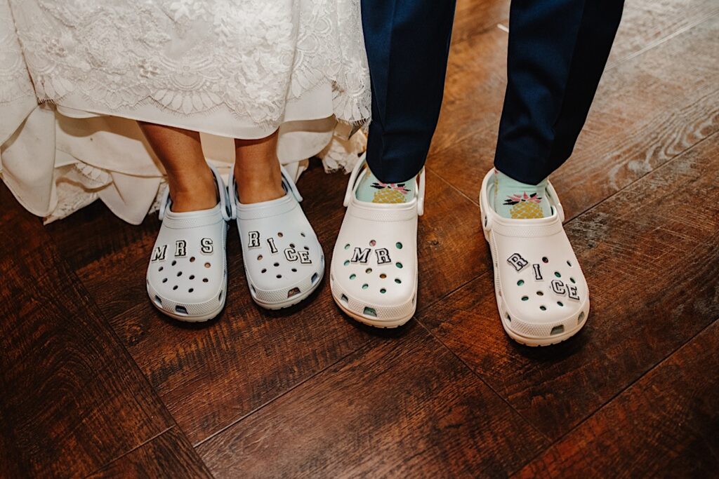 A bride and groom show off their wedding day crocs at their Wisconsin wedding reception.