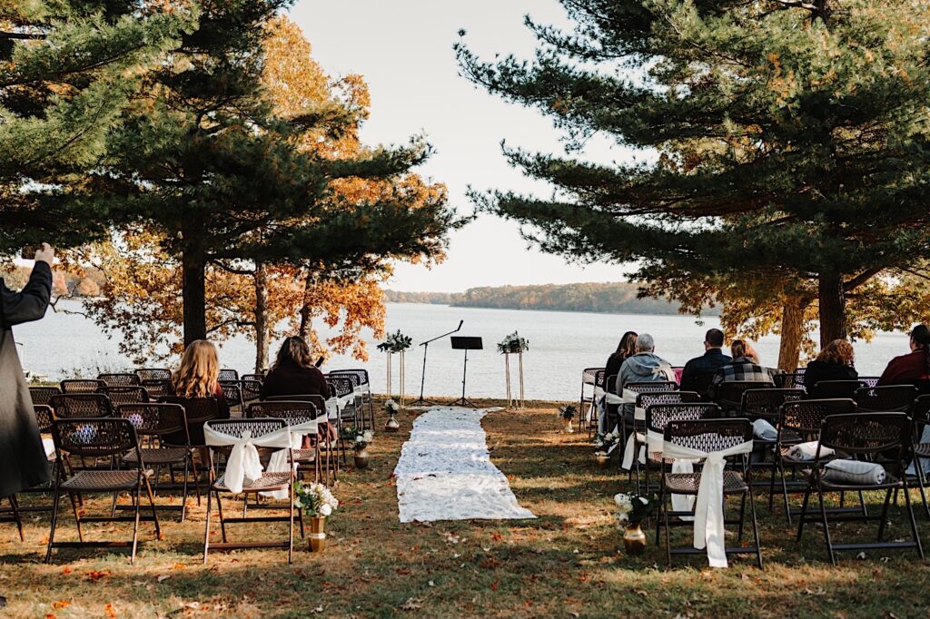 A wedding ceremony space set up for an intimate wedding in front of a lake in the Fall just outside of Bloomington Illinois