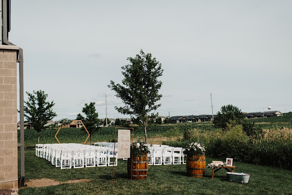 A wedding ceremony space set up outdoors next to the couples wedding venue, Destihl Brewery in Normal, Illinois