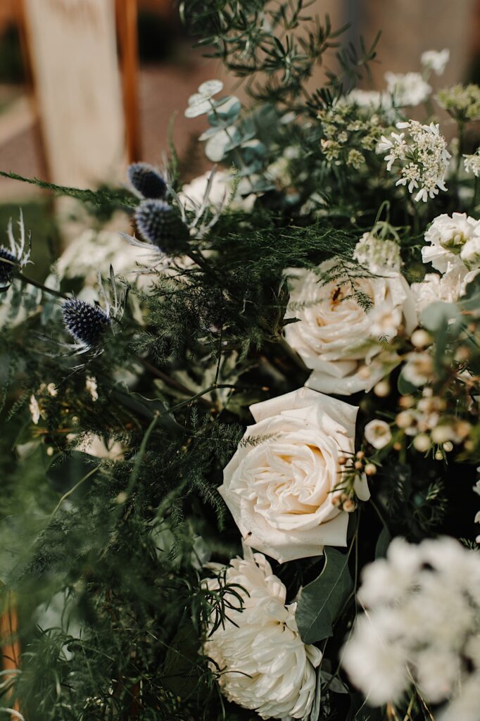 Close up detail photo of white and dark blue wedding flowers