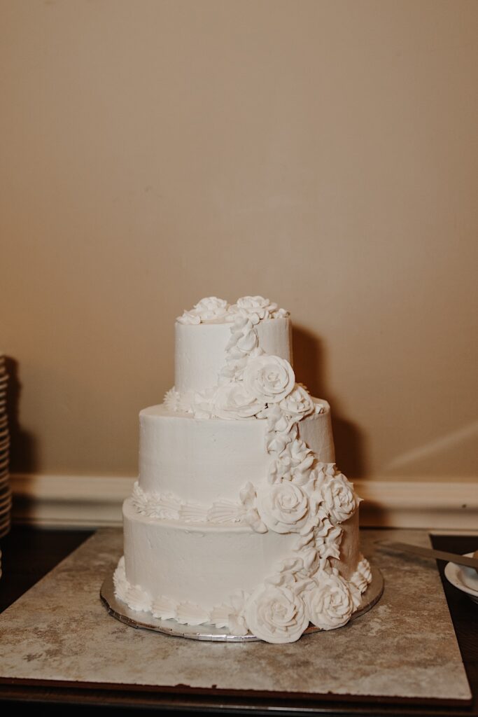 A white wedding cake sits on a table