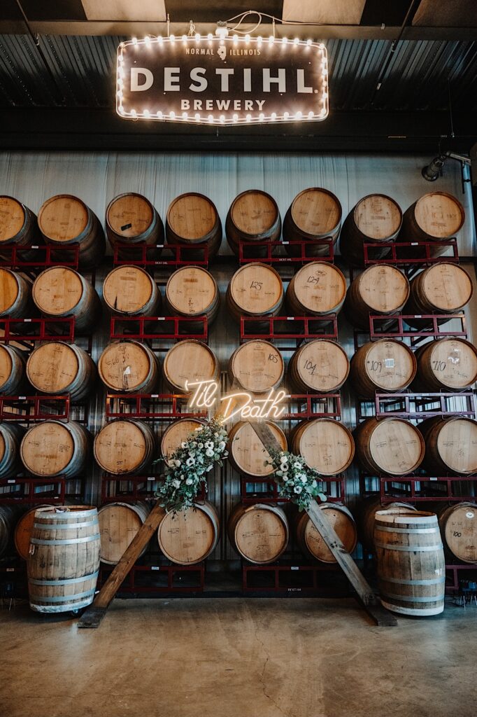 The barrel room of Destihl Brewery set up and decorated for a wedding ceremony