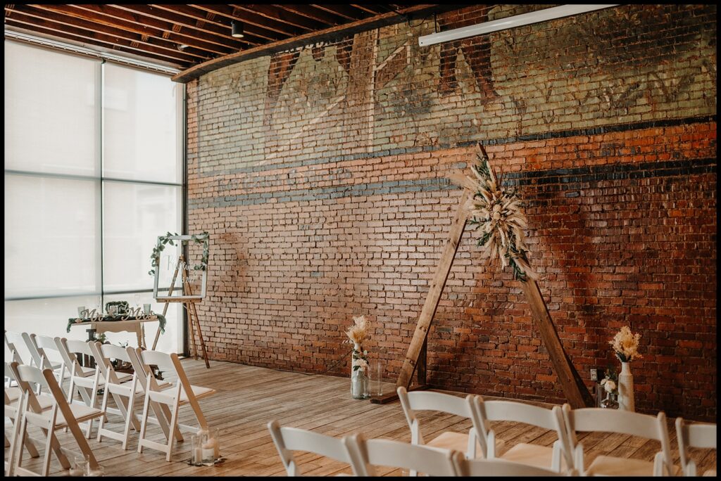 Simple ceremony setup at Reality on Monroe in downtown Bloomington, IL - one of many unique wedding venues in central il with exposed brick and urban charm